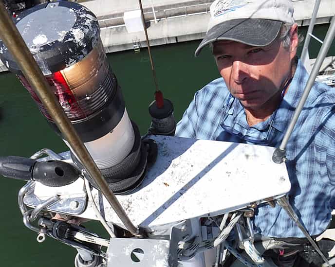 A surveyor inspecting a sailboat's rig